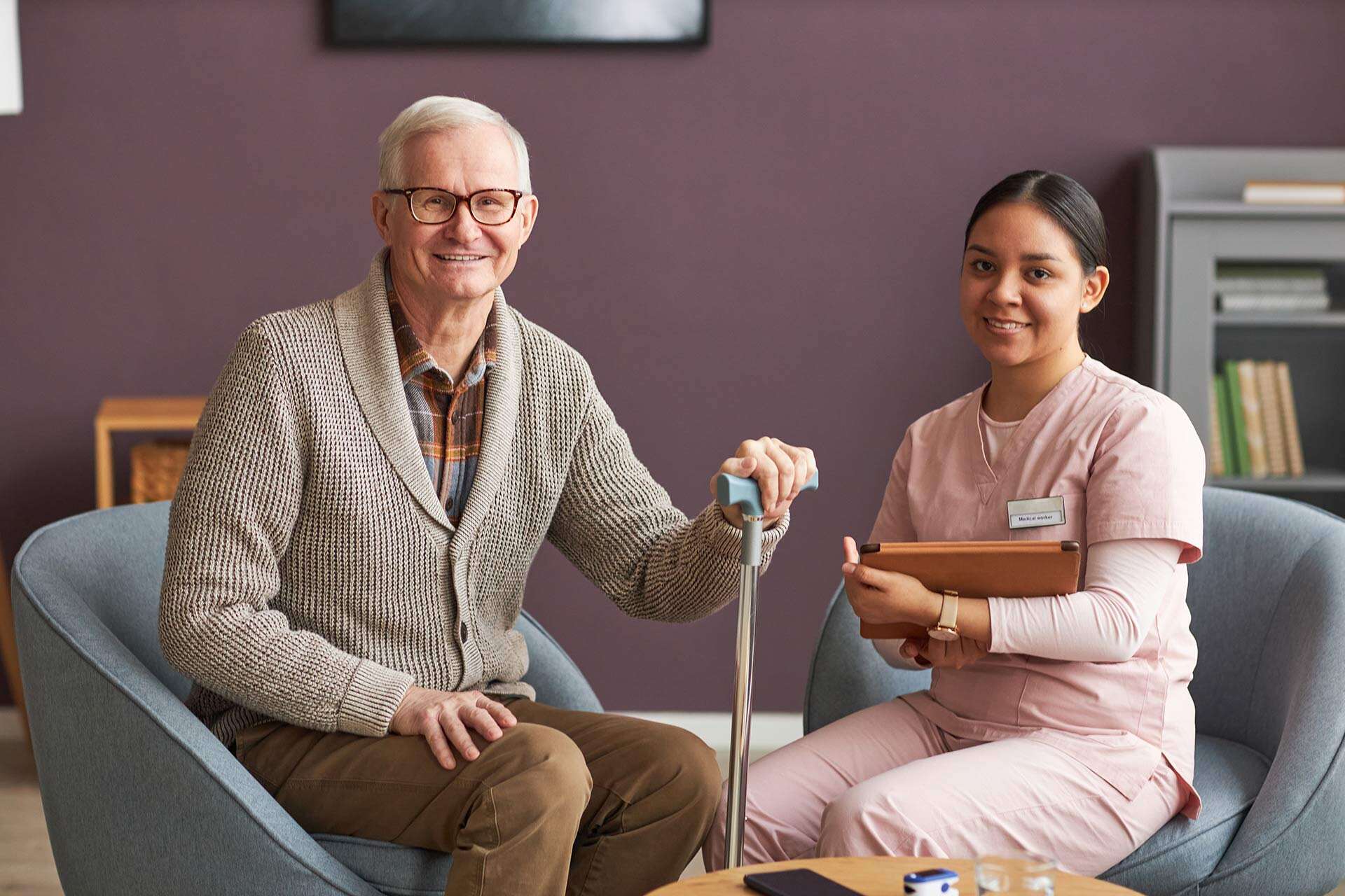 senior-man-and-social-worker-sitting-at-home-2023-11-27-05-36-06-CFB7ML3.jpg