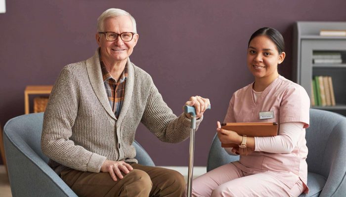 senior-man-and-social-worker-sitting-at-home-2023-11-27-05-36-06-CFB7ML3.jpg